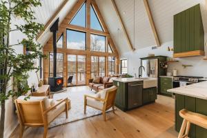 an open kitchen and living room with a vaulted ceiling at Paddle Point in West Milford