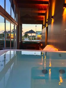 a large swimming pool in a building with an umbrella at La Siègià Resort spa in Massa Marittima