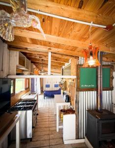 a kitchen and living room with a stove top oven at Casa en playas del sur de mar del plata, la musa beach and home in San Eduardo del Mar