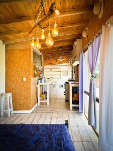 a room with a bed and a kitchen in it at Casa en playas del sur de mar del plata, la musa beach and home in San Eduardo del Mar +4 photos