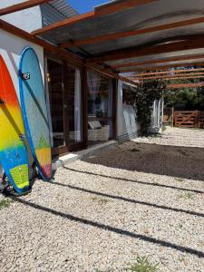 two surfboards are parked next to a building at Casa en playas del sur de mar del plata, la musa beach and home in San Eduardo del Mar