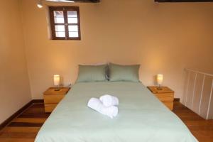 a bedroom with a bed with two towels on it at Hermoso Apartamento in Cusco