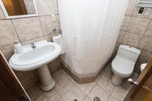 a bathroom with a sink and a toilet at Hermoso Apartamento in Cusco
