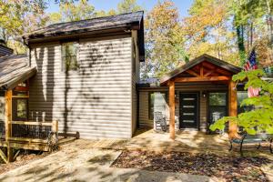 a log cabin with a porch and a deck at Hot Tub and Creek View Cabin about 6 Mi to Ellijay! in Ellijay