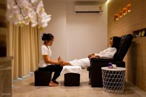 two women sitting next to each other in a room at Utopia Loft Aparthotel by Sabai Sands in Rawai Beach