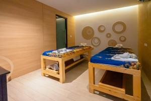 a room with two beds and a mirror at Utopia Lofts by Sabai Sands in Nai Harn Beach +29 photos
