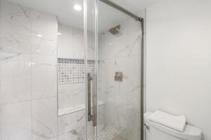 a bathroom with a shower with a toilet at Elegant Maui Banyan, Pool, Hot Tub, Across Kamaole II Beach Park in Wailea +47 photos