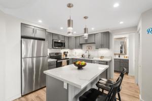 a kitchen with stainless steel appliances and a white counter top at Elegant Maui Banyan, Pool, Hot Tub, Across Kamaole II Beach Park in Wailea
