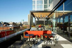 a balcony with a table and chairs on a building at citizenM Boston North Station in Boston