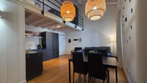 a dining room and living room with a table and chairs at BG Suite in Bergamo