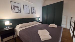 a bedroom with a bed with two towels on it at BG Suite in Bergamo