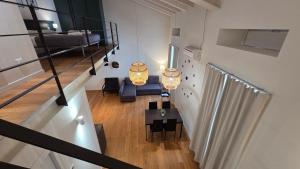 a room with a staircase with a bed and a table at BG Suite in Bergamo +22 photos