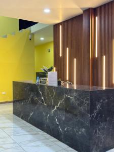 a lobby with a black counter with lights at Hotel Mochomos Huajuapan in Huajuapan de León
