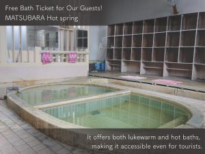 a swimming pool in a building with the words free bathucky for our guests istg at HAJIMARI Beppu in Beppu
