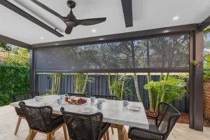 a dining room with a table and chairs at Coledale Beach Escape - Modern Comfort by the Sea in Coledale