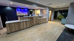 a lobby with a woman at a reception desk at Rodeway Inn in Macon