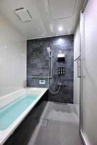 a bathroom with a tub and a shower at wanpaku99一軒家貸切 in Chosei +27 photos