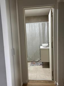 a bathroom with a toilet and a sink and a shower at Depto en Garden Puerto Santa Fe in Santa Fe