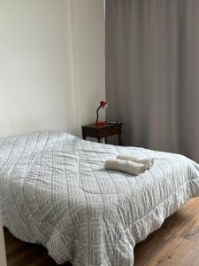 a bedroom with a bed with two towels on it at Depto en Garden Puerto Santa Fe in Santa Fe