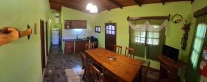 a kitchen with a wooden table in a room at Estrella del Monte in Puerto Iguazú