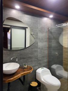 a bathroom with a sink and a mirror at Montearroyo Gualea lodge 