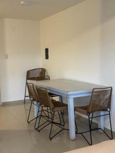 a table with chairs around it in a room at Depto Puerto Amarras III in Santa Fe