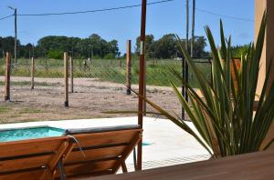 a backyard with a pool and a bench and a fence at Quinta Natural Glam in San Vicente