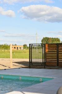 a batting cage with a gate and a pool of water at Quinta Natural Glam in San Vicente