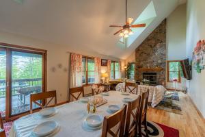 a dining room and living room with a table and chairs at Leaf Peeper's - HUGE deck, pizza oven, Pac-man! in Davis