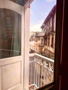 an open window with a view of a city at La Mancha Art Hostel in Valparaíso