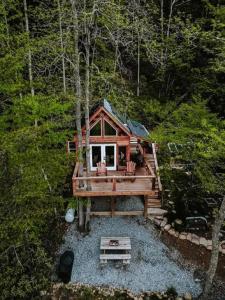 a cabin in the middle of a forest at Stunning Pet-Friendly Treehouse for Relaxing Glamping Retreats in North Carolina in Retreat