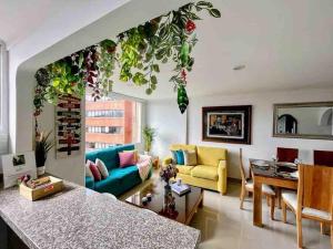 a living room with a couch and a table at Luxury Triplex Penthouse with Balcony and Stunning Mountain Views in Bogotá