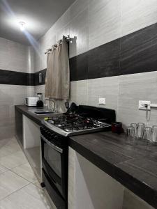 uma cozinha com fogão e bancada em The CaSa em Saltillo
