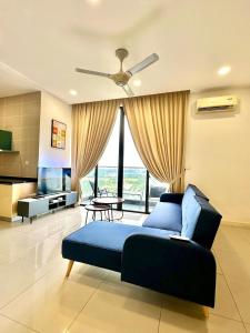 a living room with a blue bed and a television at D Pristine 4 bedroom apartment 2025 opposite legoland and medini in Iskandar Puteri