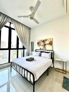 a bedroom with a bed with a ceiling fan at D Pristine 4 bedroom apartment 2025 opposite legoland and medini in Iskandar Puteri +11 photos