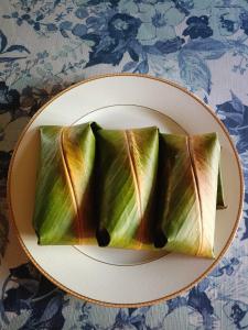 a plate of food on top of a table at Bulan And Daud Homestay in Bario