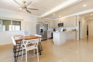 a kitchen with a table and a ceiling fan at Dream Diamond in Saint Annʼs Bay