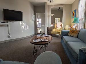 a living room with a couch and a table at Group Basecamp 6 Bedrooms Downtown GJ in Grand Junction