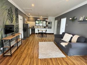 a living room with a couch and a kitchen at Prospect Cottage B in Gqeberha