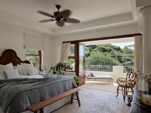 a bedroom with a bed and a balcony at Raes on Wategos in Byron Bay +81 photos