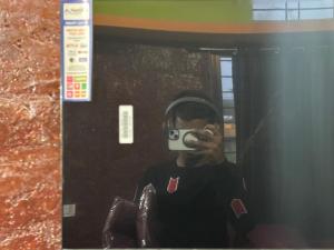 a person taking a picture in a mirror with a camera at DANDELI NAKADI Home Stay in Dandeli