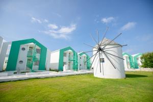 a windmill sitting in front of a building at Pricia Resort Yoron in Yoron