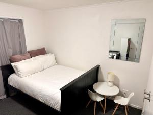 a small bedroom with a bed and a small table at Sunny Shackell - Echuca Moama Holiday Accommodation in Echuca +13 photos