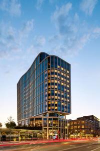 a tall glass building with a street in front of it at citizenM Boston Back Bay in Boston