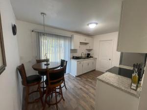 a kitchen and dining room with a table and chairs at That cute house on Emerald! in Palm Bay