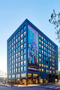 a large blue building with a painting on it at citizenM Seattle Pioneer Square in Seattle
