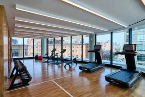 a gym with treadmills and exercise bikes in a room with windows at citizenM Boston Back Bay in Boston
