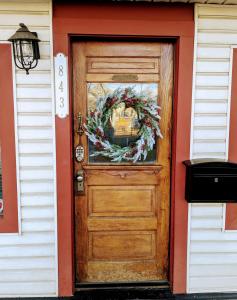a door to a house with a wreath on it at Group Basecamp 6 Bedrooms Downtown GJ in Grand Junction