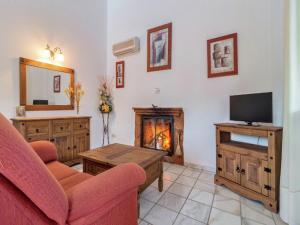 a living room with a couch and a fireplace at Scenic Bungalow Retreat in Pozo Alcon in Cuenca