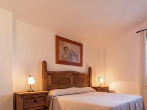 a bedroom with a bed and a picture on the wall at Scenic Bungalow Retreat in Pozo Alcon in Cuenca +15 photos
